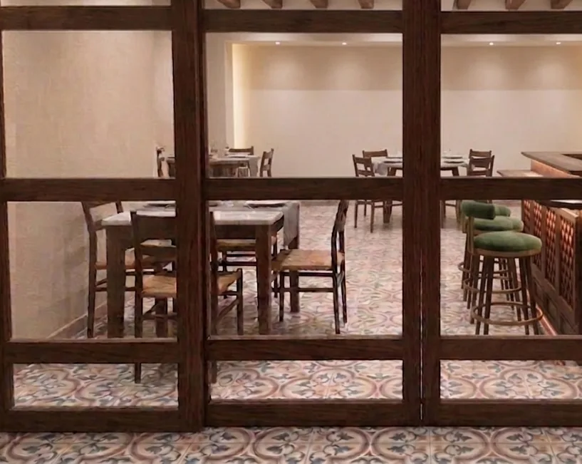 Looking through the wood-framed entrance into the vegetarian dining room at La Maison Pondichéry